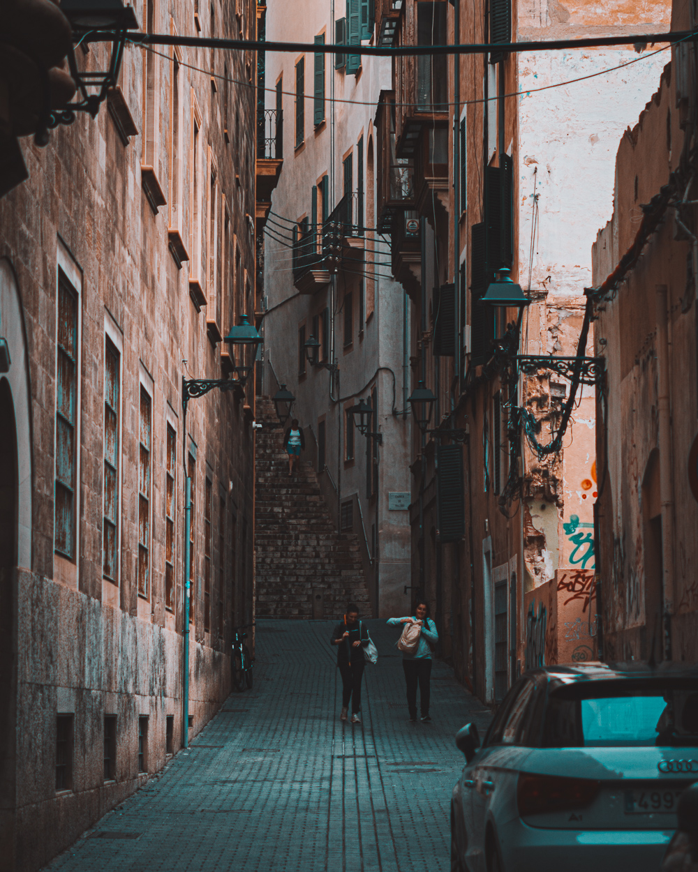 People walking down a narrow street in Palma de Mallorca