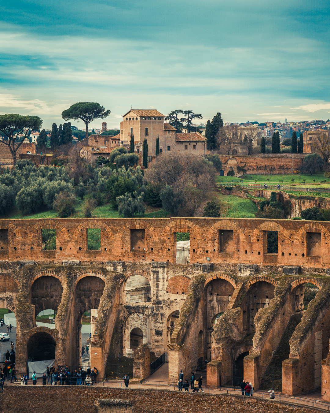 Colosseum arches from inside the Colosseum with the Roman Forum in the background