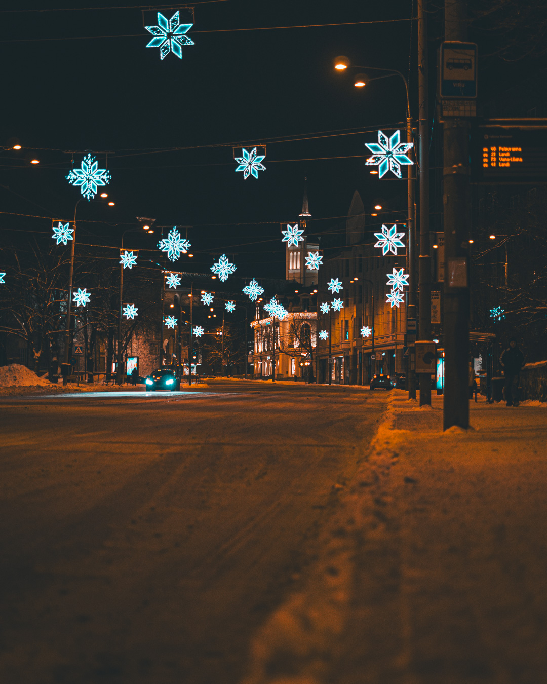 Snowy main street with snowflake lights