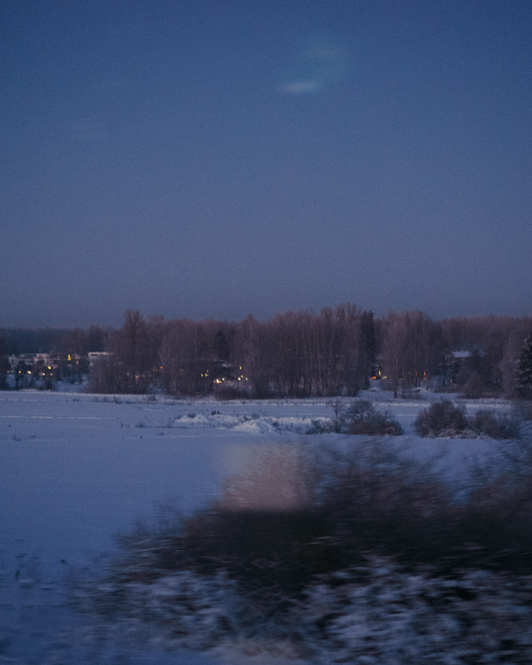 Snowy countryside with sparse houses